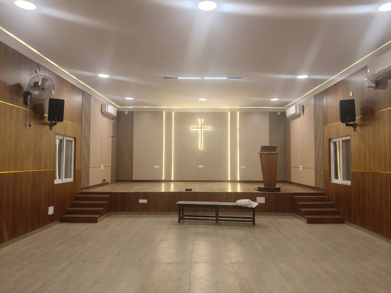 Completed church interior with coordinated wall and stage finishes